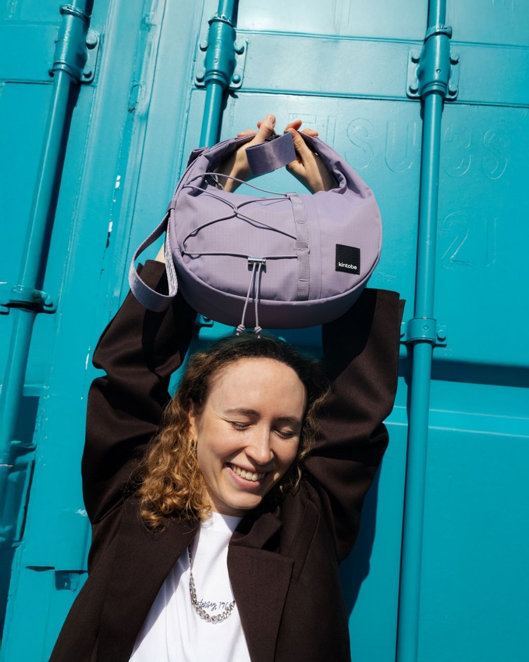 Person wearing HAZE crossbody bag in Concrete Lilac