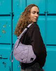 Person wearing HAZE crossbody bag in Concrete Lilac